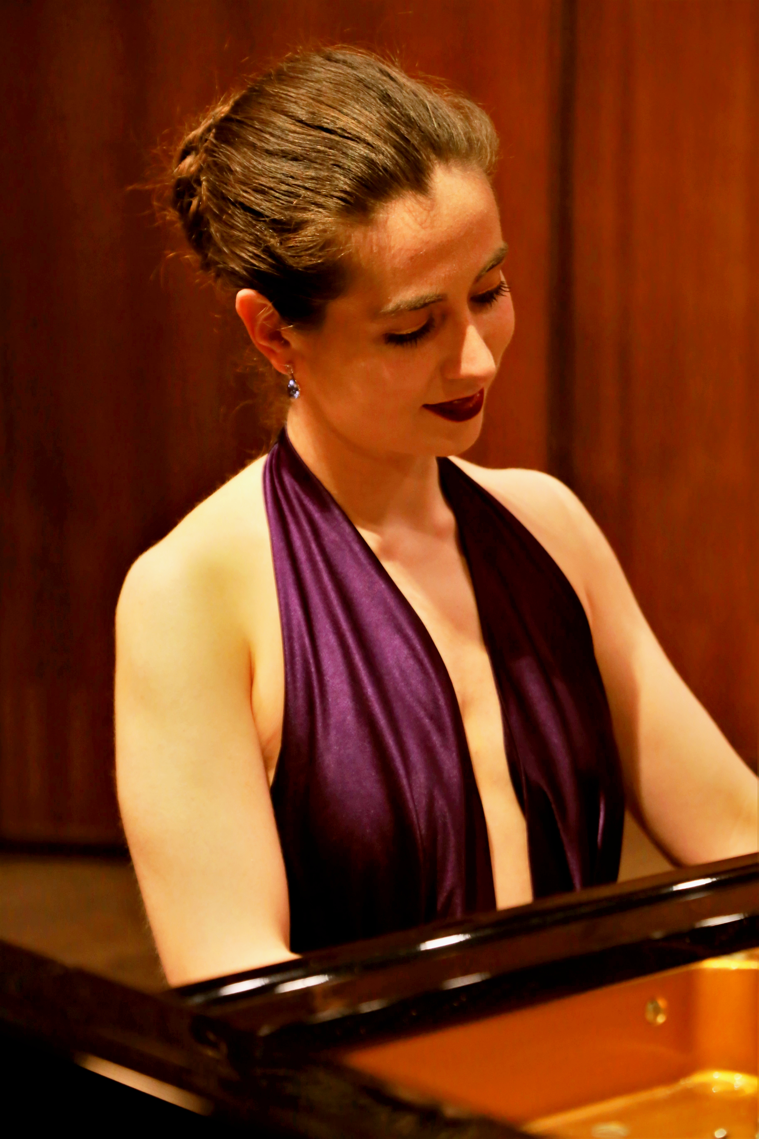 portrait shot of Judith Valerie, wearing a purple halter-neck dress by Zimbabwean designer Linda Mafuba